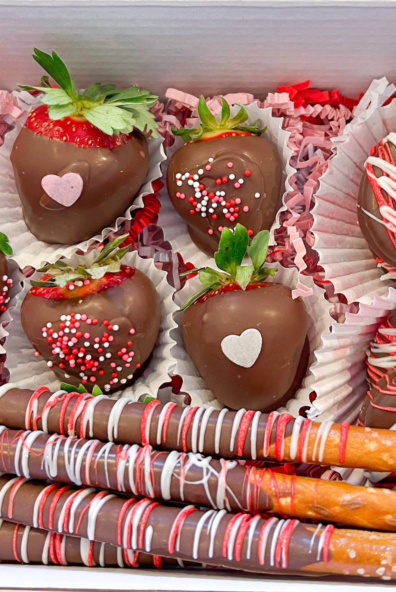 Valentine's Day themed chocolate covered strawberries and pretzels