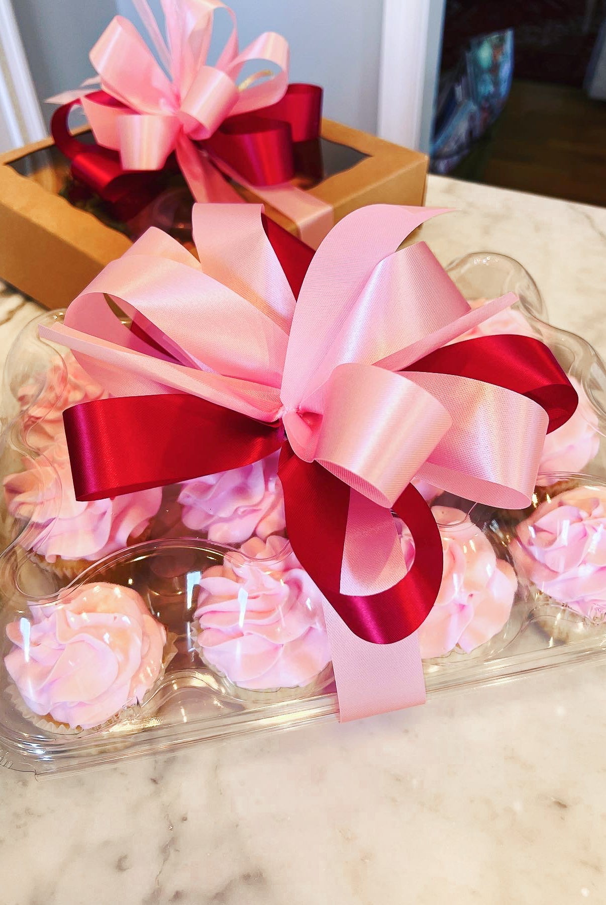 Pink cupcakes packaged for delivery with a box in Tuscaloosa Alabama