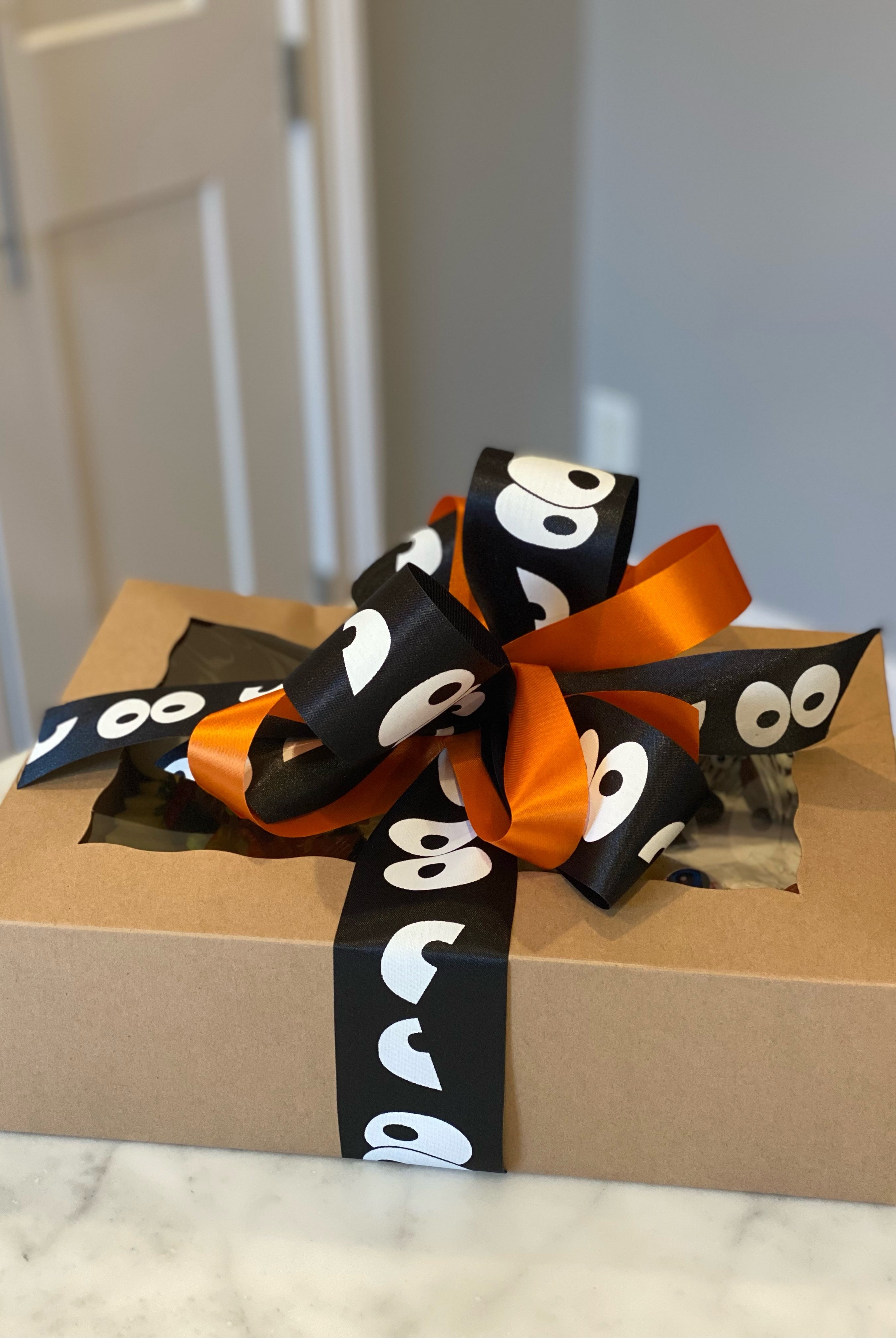 Packaged with a black and orange bow for halloween delivery.