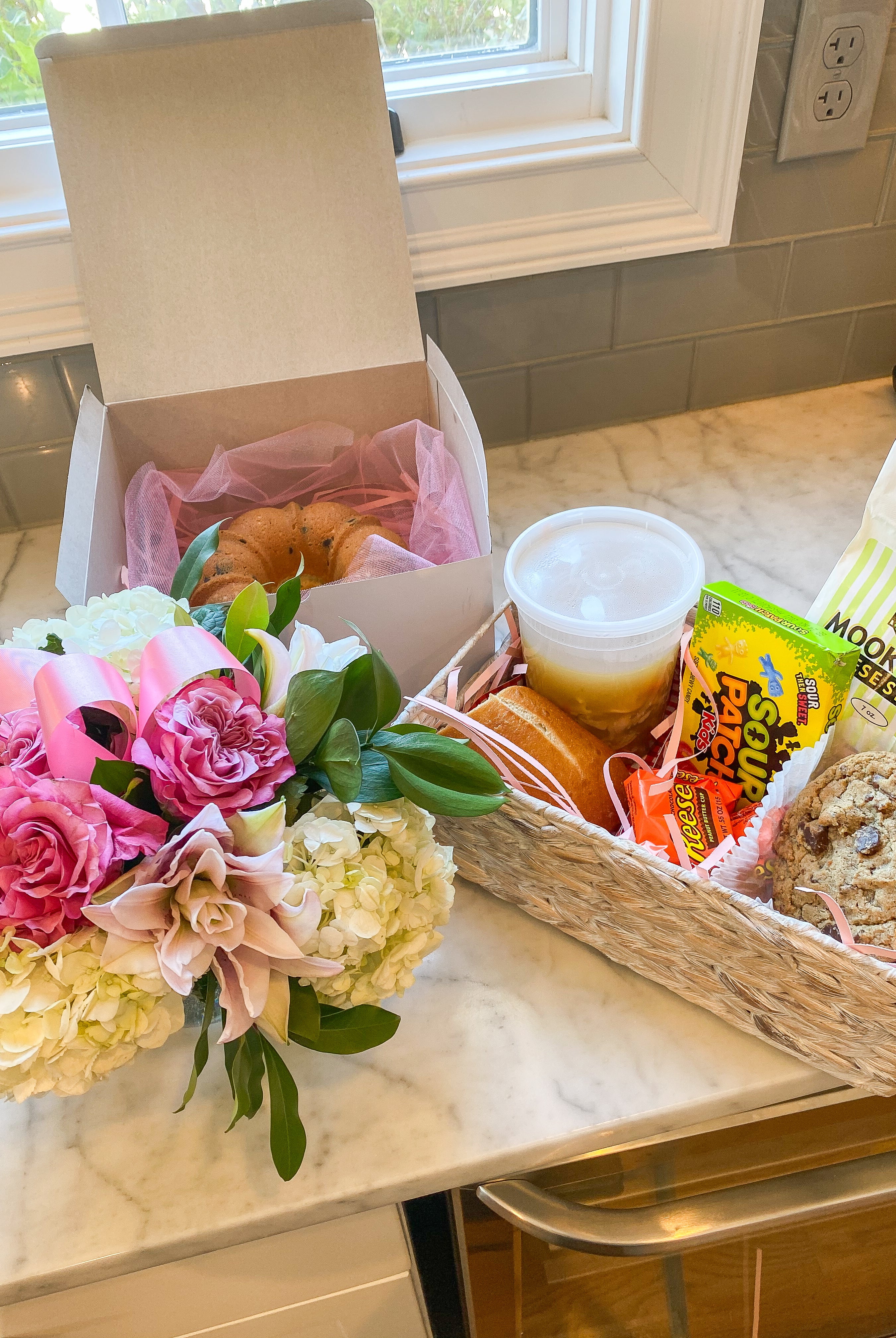Get well soon basket with flowers, cake, soup and treats