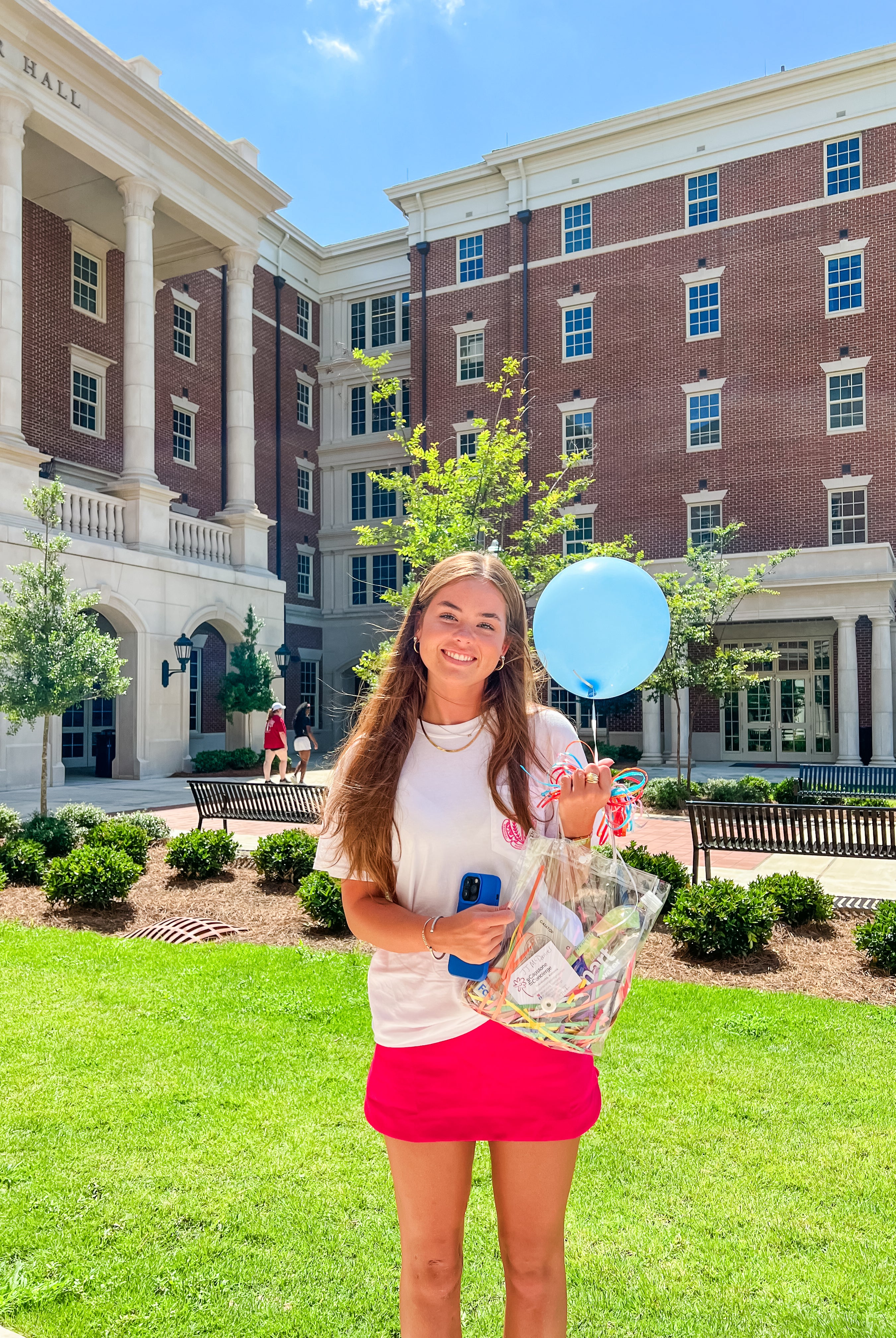 University of Alabama student outside Tutwiler Hall with her Recruitment happy delivery during Bama Rush week