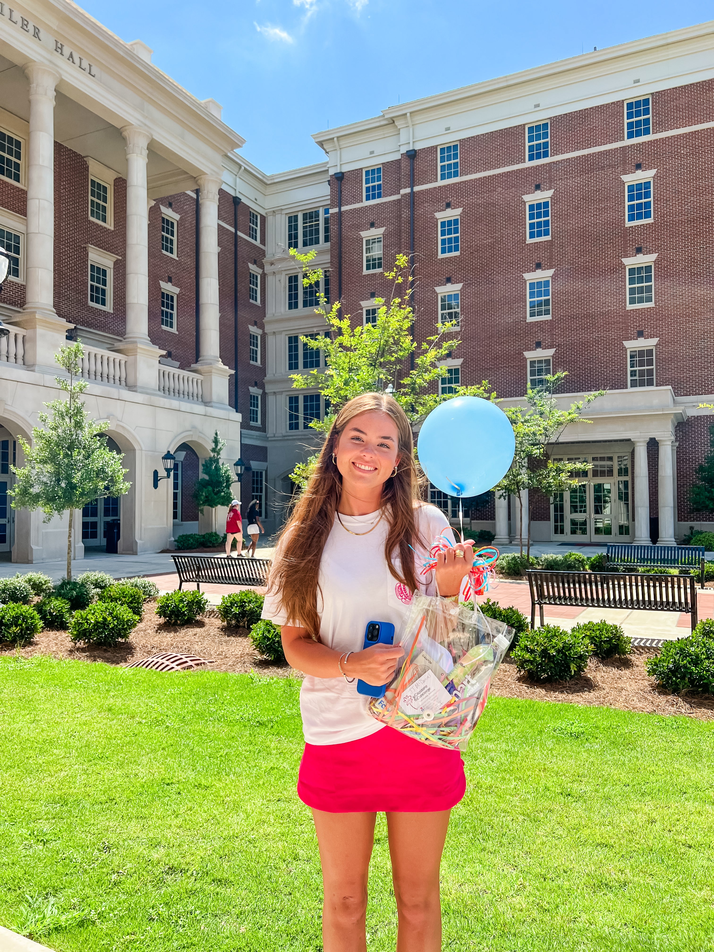 University of Alabama student outside Tutwiler Hall with her Recruitment happy delivery during Bama Rush week